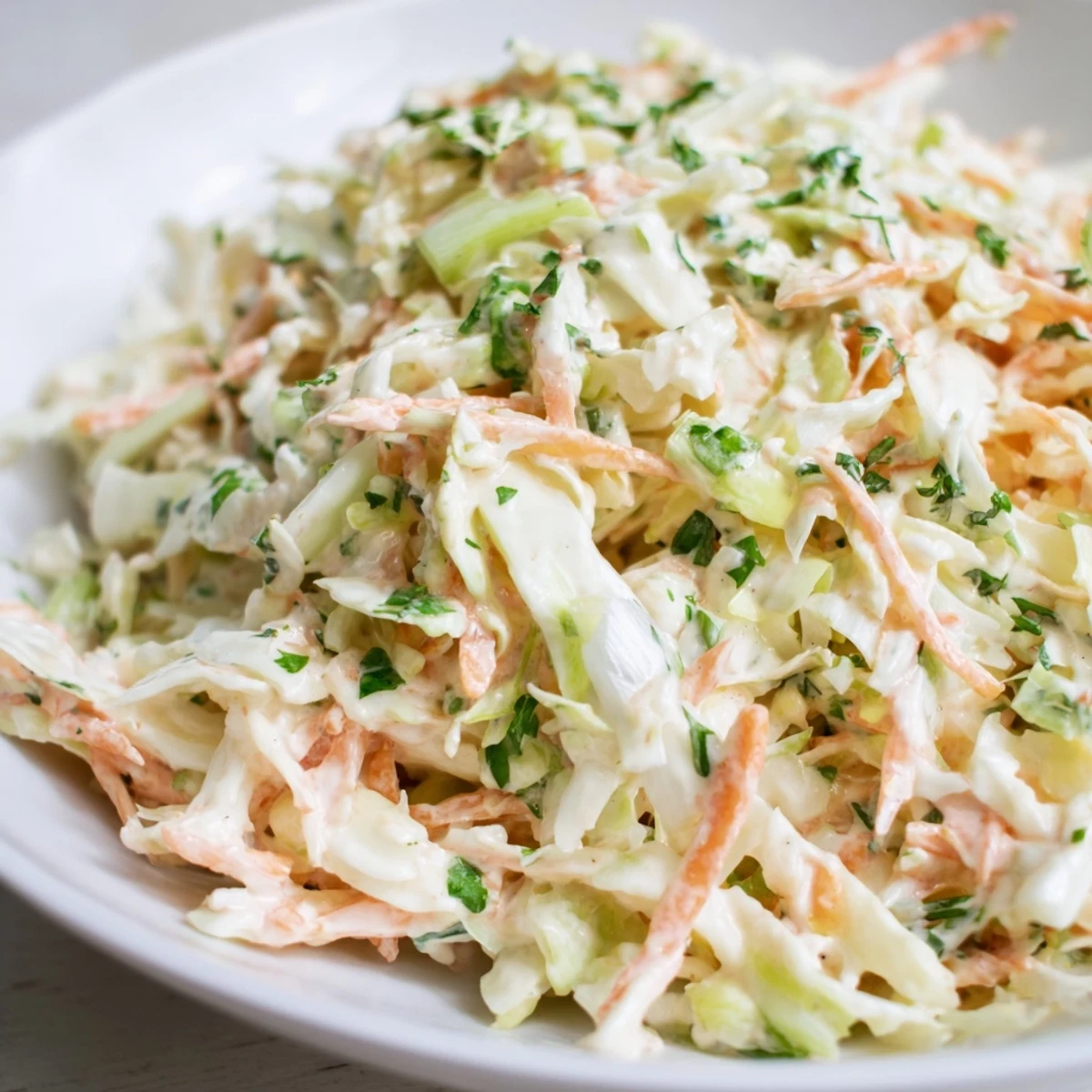 Sweet and tangy coleslaw with apple, a cold, refreshing side dish to complement any meal.