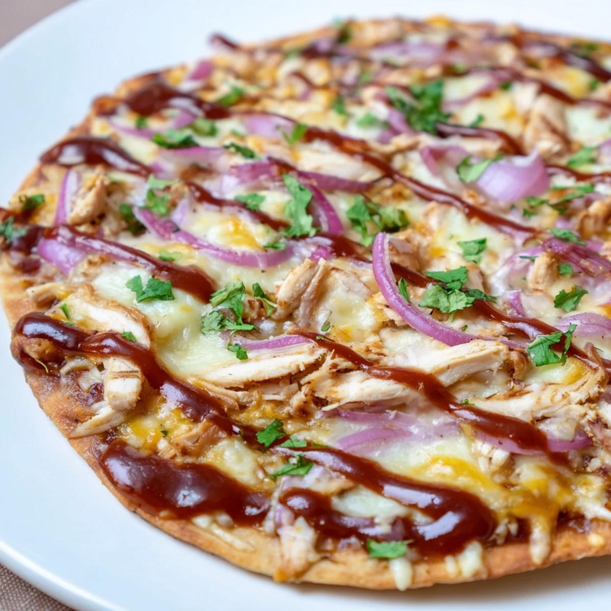 Golden-crusted Chicken BBQ Pizza with melted cheese, grilled chicken, and red onions ready to enjoy.