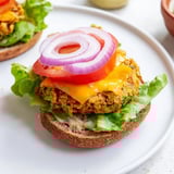 Golden-brown veggie burger patties on a toasted bun, ready for a delicious bite.