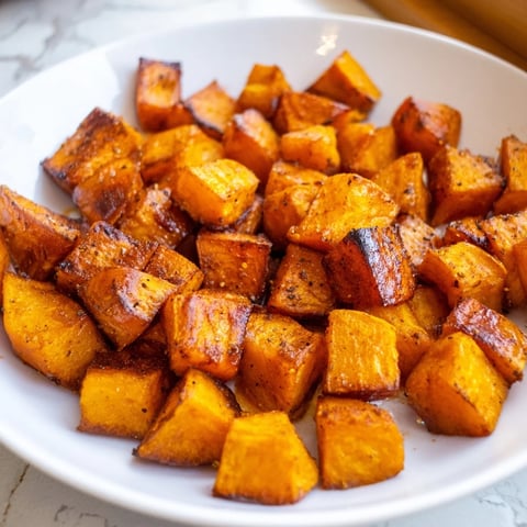 Golden, caramelized roasted sweet potatoes, a simple side dish bursting with savory spices and flavor.