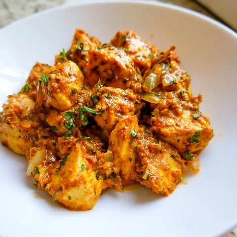 Chicken Tikka Masala, a rich, creamy Indian-American dish, with vibrant red sauce and tender chicken.