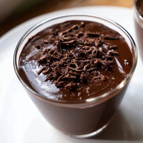 A chilled glass of creamy chocolate pudding, a decadent dessert to savor after dinner.
