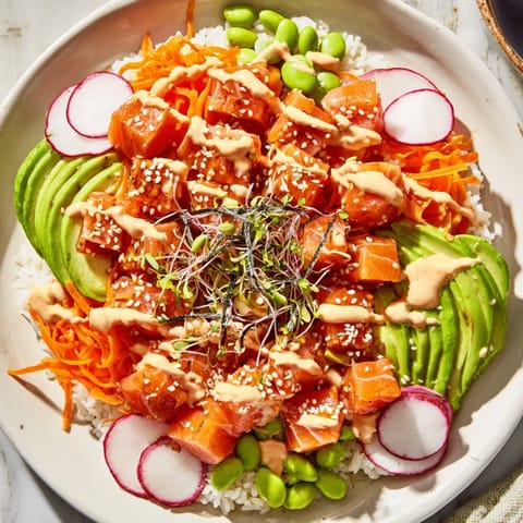 A colorful close-up of a homemade poke bowl showcasing fresh salmon and rice details.