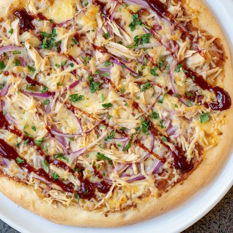Flavorful Chicken BBQ Pizza topped with smoky gouda, perfect for a weeknight dinner with friends.