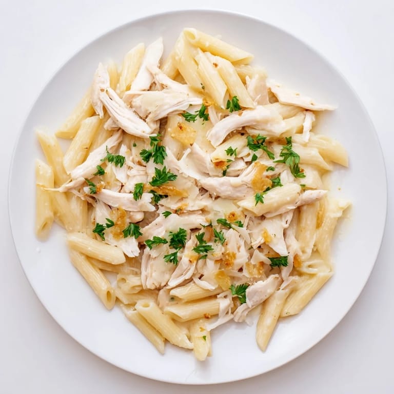 Hearty Roasted Garlic Chicken Penne served steaming hot, showcasing tender pasta coated in rich cream sauce.